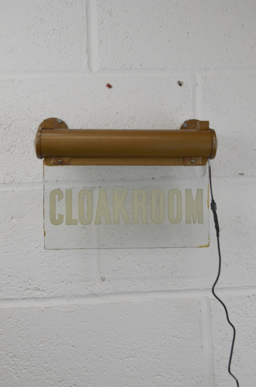 A CLOAKROOM illuminated 'Internalite' directional sign