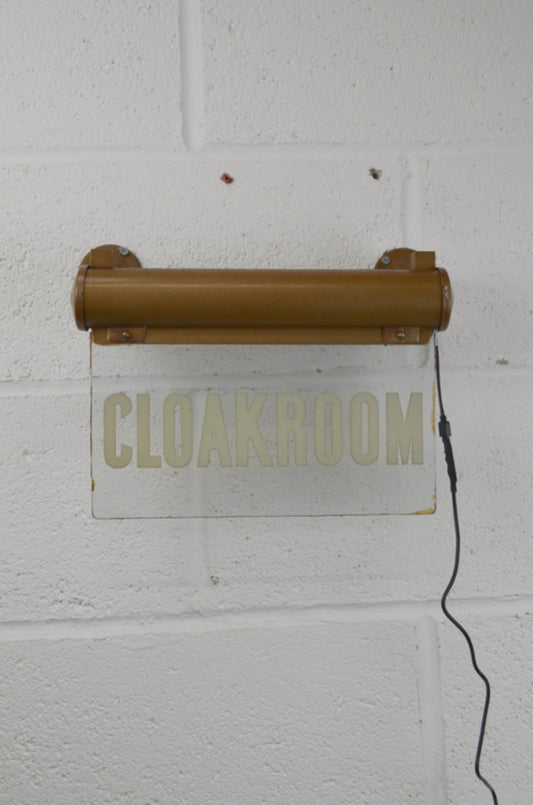 A CLOAKROOM illuminated 'Internalite' directional sign